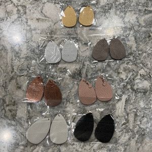 Set of 7 faux leather earrings. All silver hardware. Comes with plastic stopper.